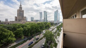A cityscape with modern and historic buildings, a busy road, and green trees. - ShortStayPoland Świętokrzyska - B38 (Warsaw)