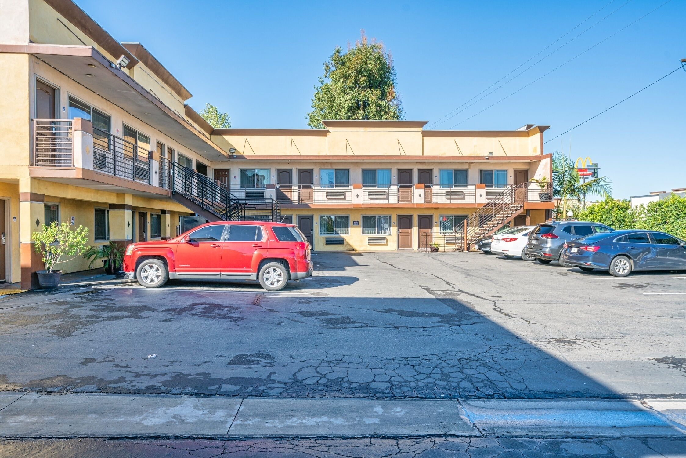 A multi-story motel with a parking lot.