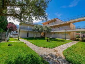 A two-story building with a stone pathway leading to the entrance. - Rescator Resort 118 - One Bedroom Apartment, Sleeps 4 (Roses)
