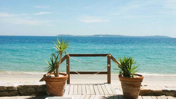 A wooden deck with a metal frame structure, overlooking a calm sea with distant land. - Villa for 6 People with Pool and Unobstructed View (LA LONDE LES MAURES)