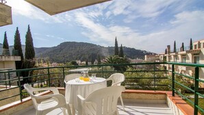 A balcony with a table and chairs, overlooking a mountainous landscape. - Rescator Resort 205 - One Bedroom Apartment, Sleeps 4 (Roses)