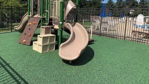 A playground with a slide and climbing structures. - Experience All 7 Springs Has to Offer in This Great Townhouse (Champion)