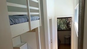 A modern interior with a bunk bed, a staircase, and a small table. - Beautiful Beach-side cottage with lap pool in North Maroubra close to Coogee (Maroubra)