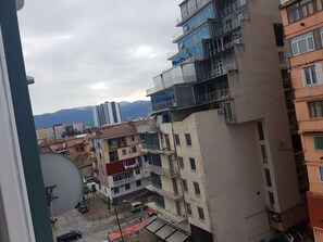 A multi-story building with balconies and a satellite dish.