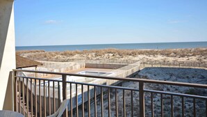 A balcony with a view of the beach and ocean. - Traditional 1 Bedroom Oceanfront Condo with Free WiFi, an Outdoor Pool, and a Wonderful View Located in Midtown and Mere Steps to the Beach! (Ocean City)