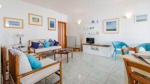 A spacious living room with a sofa, chairs, a coffee table, and a TV. - Apartment/ flat - Scicli (Donnalucata)
