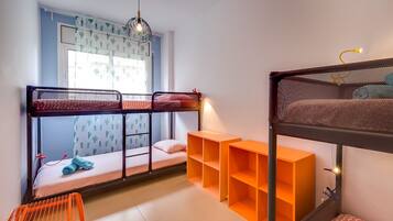 Cozy sleeping space with a bunk bed arrangement and shelves for storage.