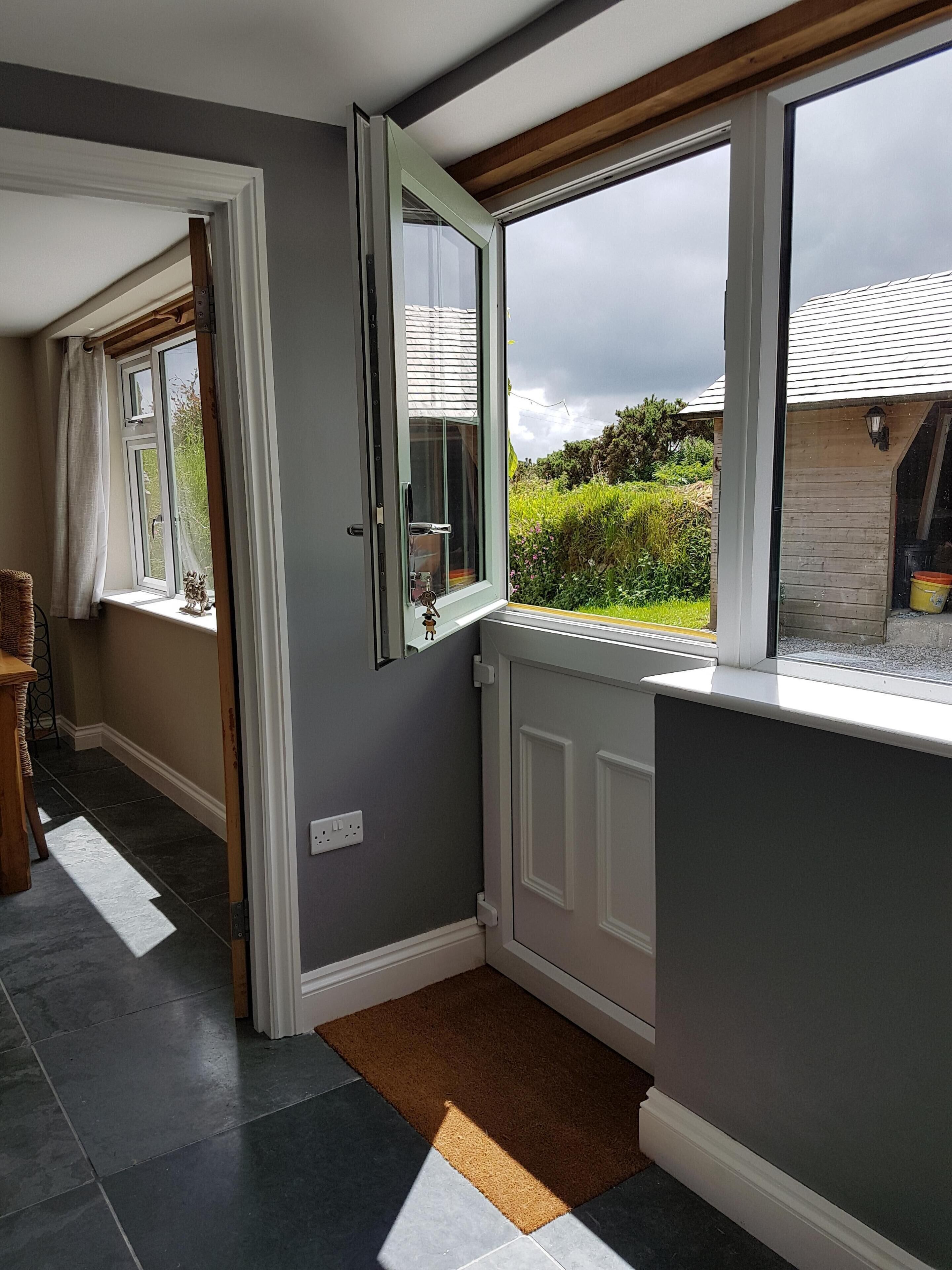 A hallway with a window, a door, and a radiator.