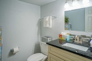 A bathroom with a toilet, sink, and towel rack. - King bed, Queen bed, 2 TV's,  Walk to Old Town (Albuquerque)