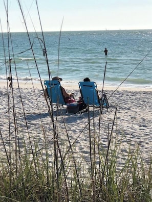 Two beach chairs facing the ocean with a clear view of the sea and distant boats. - Oceanview Gulf-Front 2BR/2BA | Pass-a-Grille Beach (Saint Pete Beach)