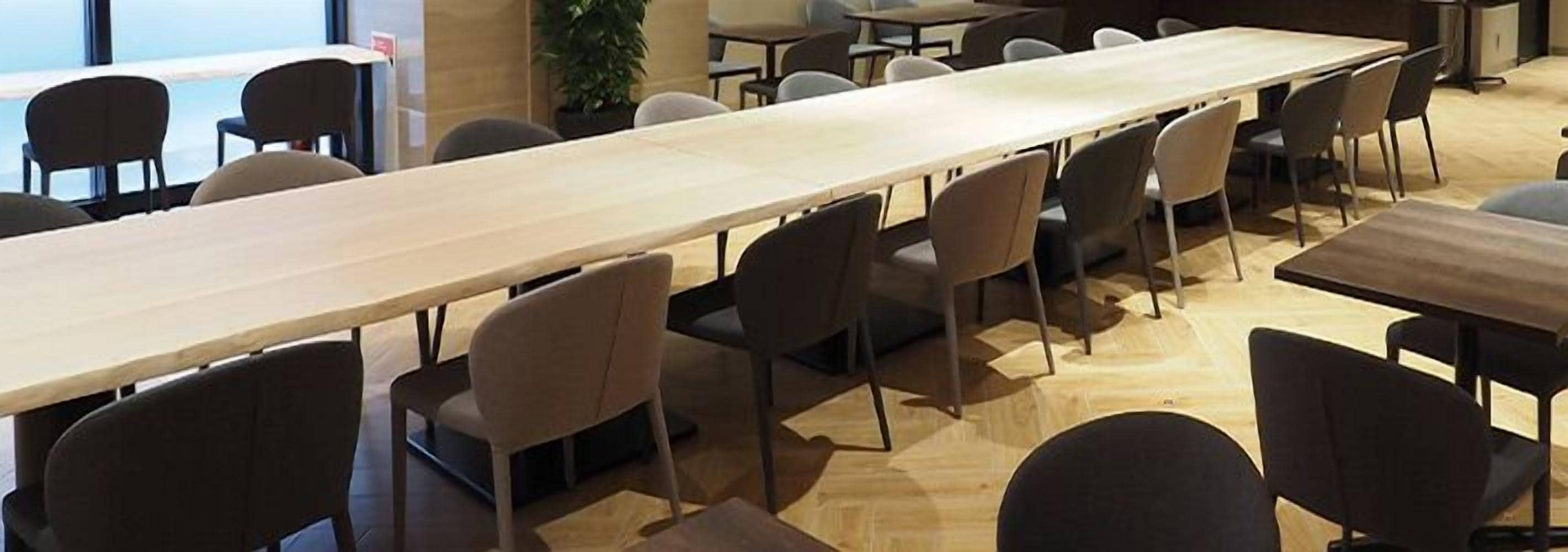 A conference room with a long table and multiple chairs.