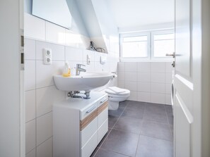 Een douche, een haardroger, zeep, toiletpapier