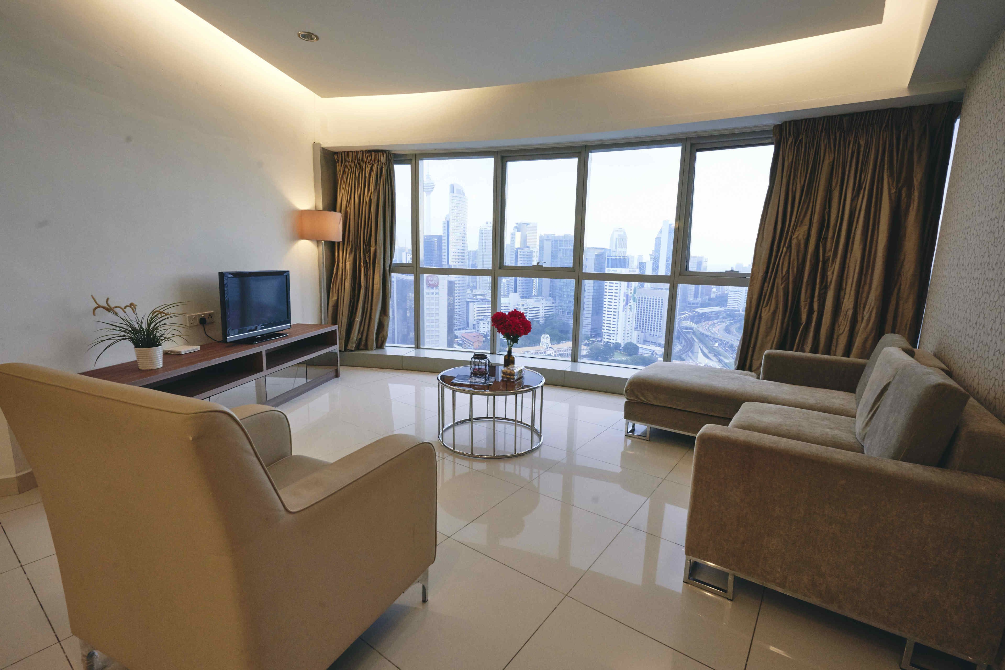 A modern living room with a large window, a flat-screen TV, and two sofas.