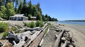 A coastal property with a covered patio and a cabin. - "Driftwood Island Retreat" Spectacular View, Private Waterfront on James Point. (Vashon)