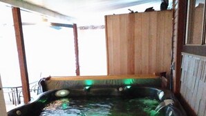 A hot tub with a wooden exterior, a metal railing, and a view of the outdoors. -  Miles to VIR, Caesar's VA Casino,  Martinsv'l , S.Boston, Priv. Pool seasonal! (Sutherlin)