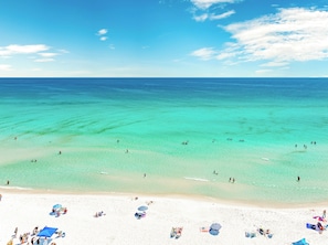 A beach with clear turquoise water, white sand, and several umbrellas. - Sun Kiss'D | Private Pool | 6-Seater Golf Cart | 4 Mins to Public Beach (Destin)