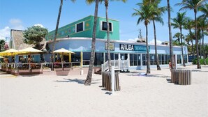 A beachfront building with a sign reading "ARUBA BEACH CLUB".