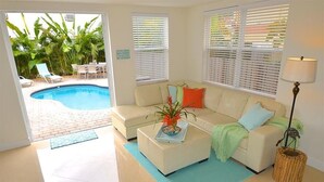 A living room with a pool, a sofa, and a lamp.