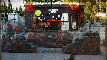 A Halloween-themed setup with a decorated booth, pumpkins, and a spider web.