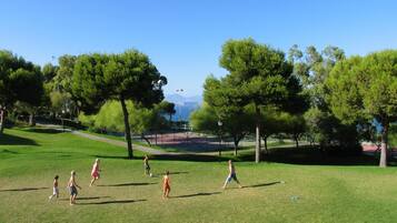 Un parc verdoyant, avec des arbres et un ciel dégagé.