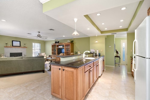 This beauty is centrally located,  with a heated pool and water fall!