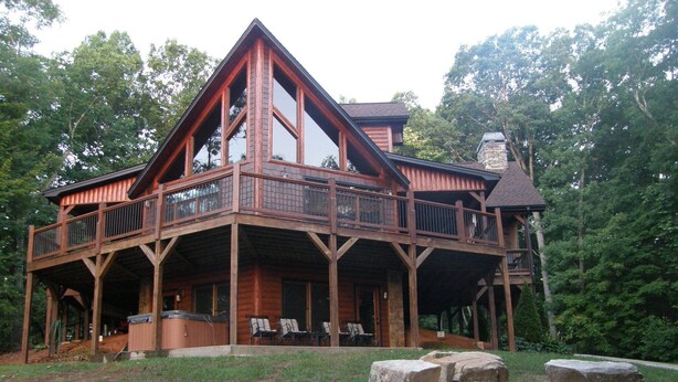 A large wooden cabin with a wrap-around porch, multiple decks, and a stone chimney. - 3 King Suites! Great Views! Outdoor Fireplace! Paved Roads! Pets! Access Ramp! (Blue Ridge)