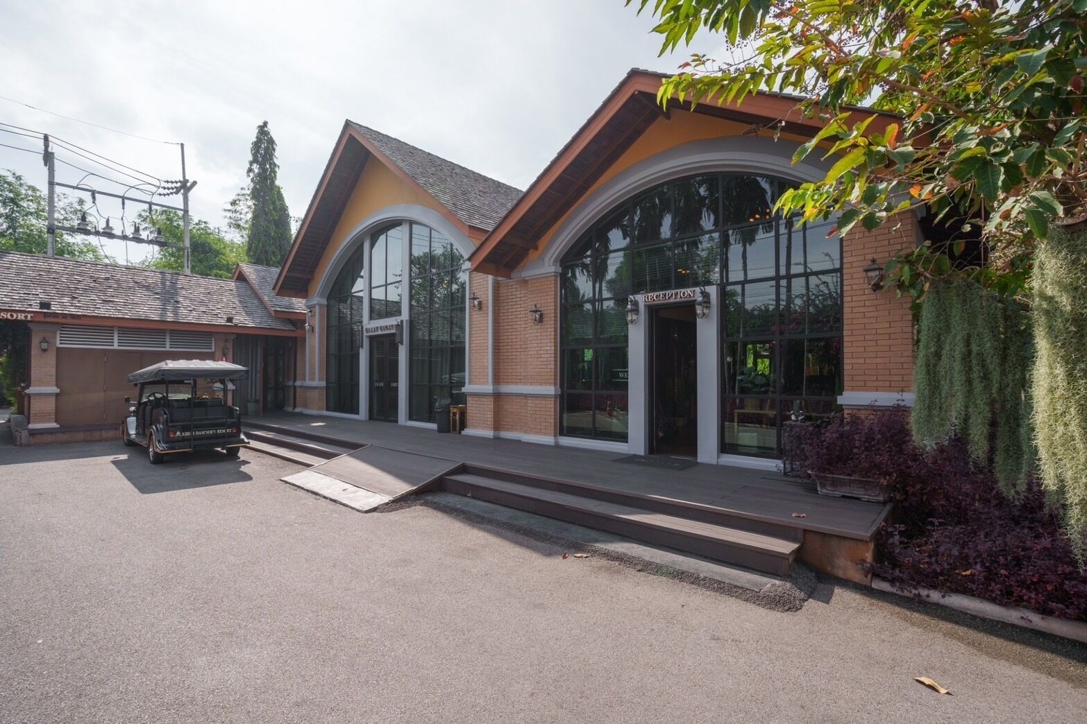 A building with a reception area, a golf cart, and a parking lot.