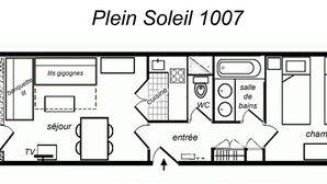 A floor plan of a hotel named Plein Soleil 1007, featuring a balcony, a sitting area, a TV, a dining area, a kitchen, a WC, a bathroom, and a bedroom.