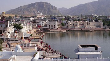 A riverside town with a prominent temple complex and a large body of water.