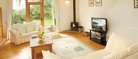 Ground floor: Open-plan sitting area with multi-fuel burning stove, dining area and kitchen