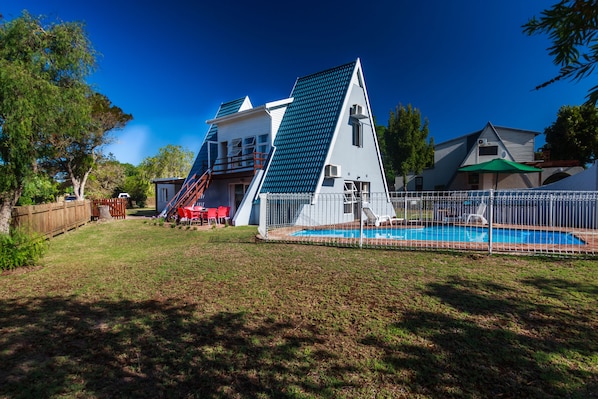 A house with a swimming pool, a fenced yard, and a slide leading to a deck. - Beach you to it - Sedgefield (Sedgefield)