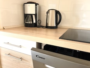 Enjoy cooking in this well-equipped kitchen with a coffee maker, kettle, and dishwasher.
