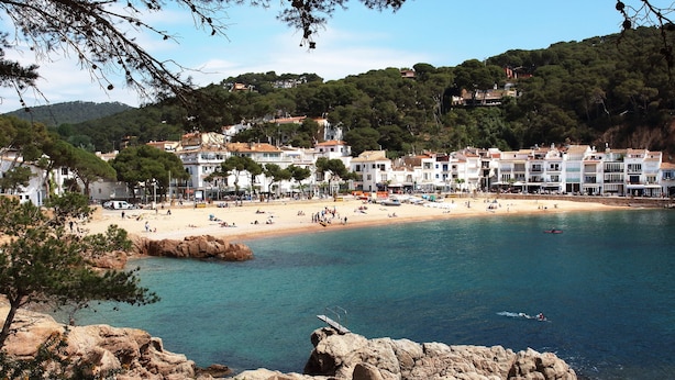 A coastal town with a sandy beach, clear blue waters, and buildings with red-tiled roofs. - Large, Luxury Villa, Sea Views, Heated Pool in Begur, Costa Brava (La Borna)