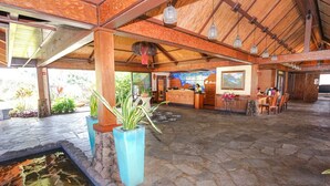 A spacious lobby with a stone floor, a reception desk, and a small water feature. - Aloha Condos, Hanalei Bay Resort, Condo 6304, Ocean View, AC (Princeville)