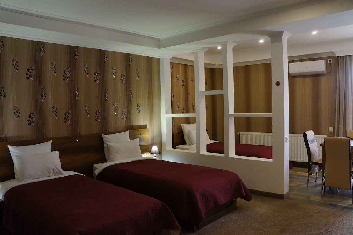 Family Room, 3 Twin Beds | Living area | Flat-screen TV