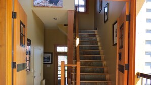 A wooden staircase with a handrail leading to an upper floor. -  Ski-In Ski-Out, Private Hot Tub, Spacious End Unit, Panoramic View (Golden)