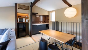 A compact living space with a kitchenette, a dining area, and a sofa. - Shirasagi Kyoto (Kyoto)
