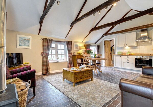 Cozy living space with a comfortable sofa, dining area, and modern kitchen.