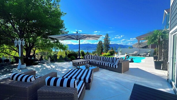 A patio with outdoor furniture, a swimming pool, and a view of mountains. - Perfect couple retreat paradise found at Casa De Luce (Kelowna)