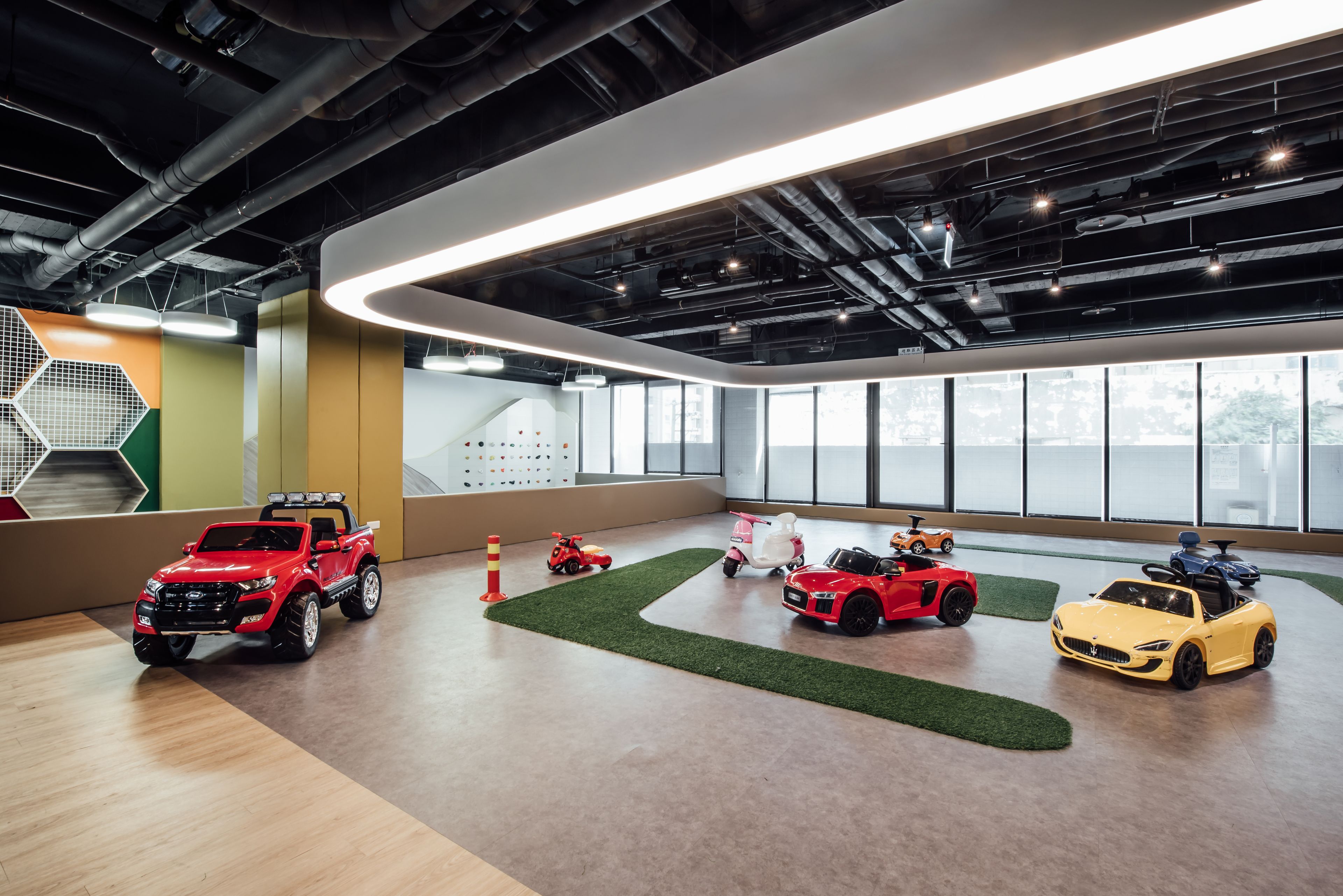 A spacious showroom with various toy cars and trucks on display.