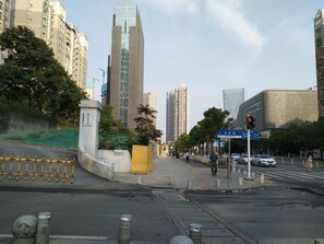 A city street with tall buildings, a pedestrian crossing, and a traffic light. - The Huiting Collection (Wuhan)