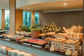 A buffet with various food items and a selection of plants. - Cicilia Saigon Center (Ho Chi Minh City)