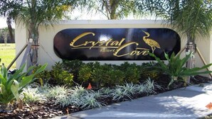 A sign for Crystal Cove Resort with a bird illustration. - Shv1189ha - 7 Bedroom Villa In Crystal Cove, Sleeps Up To 16, Just 6 Miles To Disney (Kissimmee)