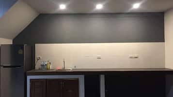 A modern kitchen with a built-in refrigerator, a countertop with a sink, and cabinets.