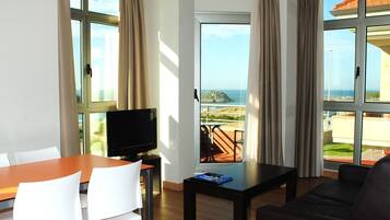 Deluxe Apartment, 1 Bedroom, Beach View | Living room | Flat-screen TV