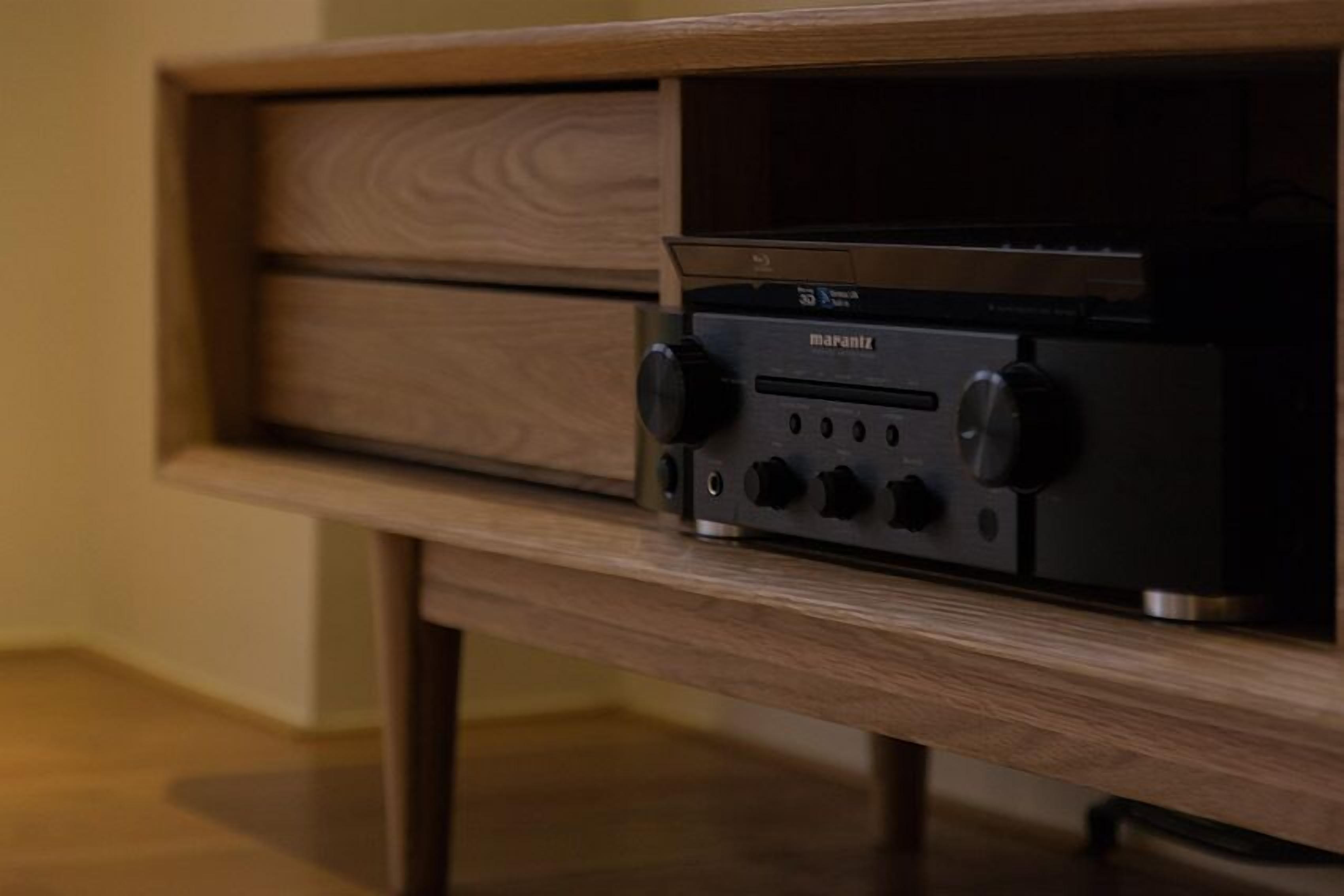 A wooden cabinet with a Marantz audio system on top.
