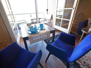 Enjoy meals for two in this stylish dining area with a large window offering a view of the outdoors.