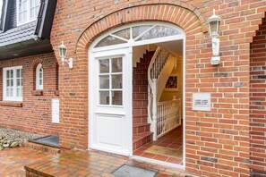 Classic brick building with a traditional entrance and staircase.
