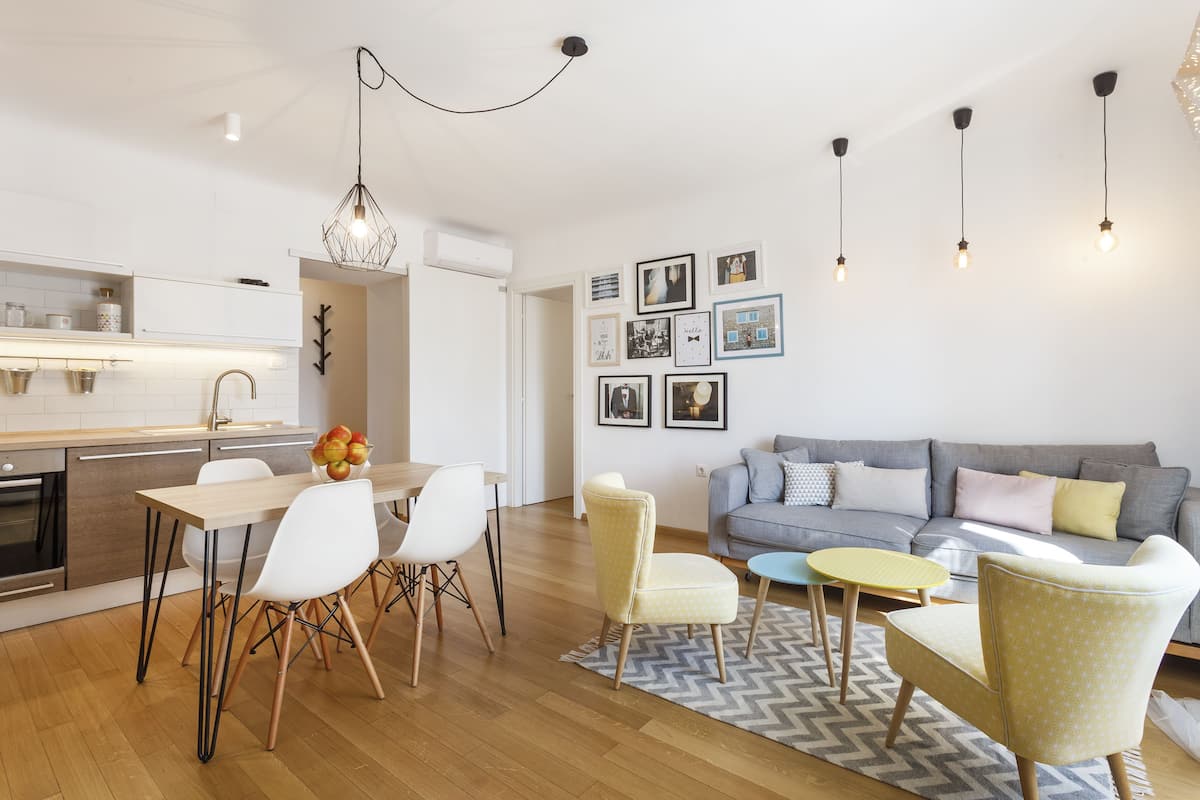 A modern living space with a kitchen, dining area, and seating area.