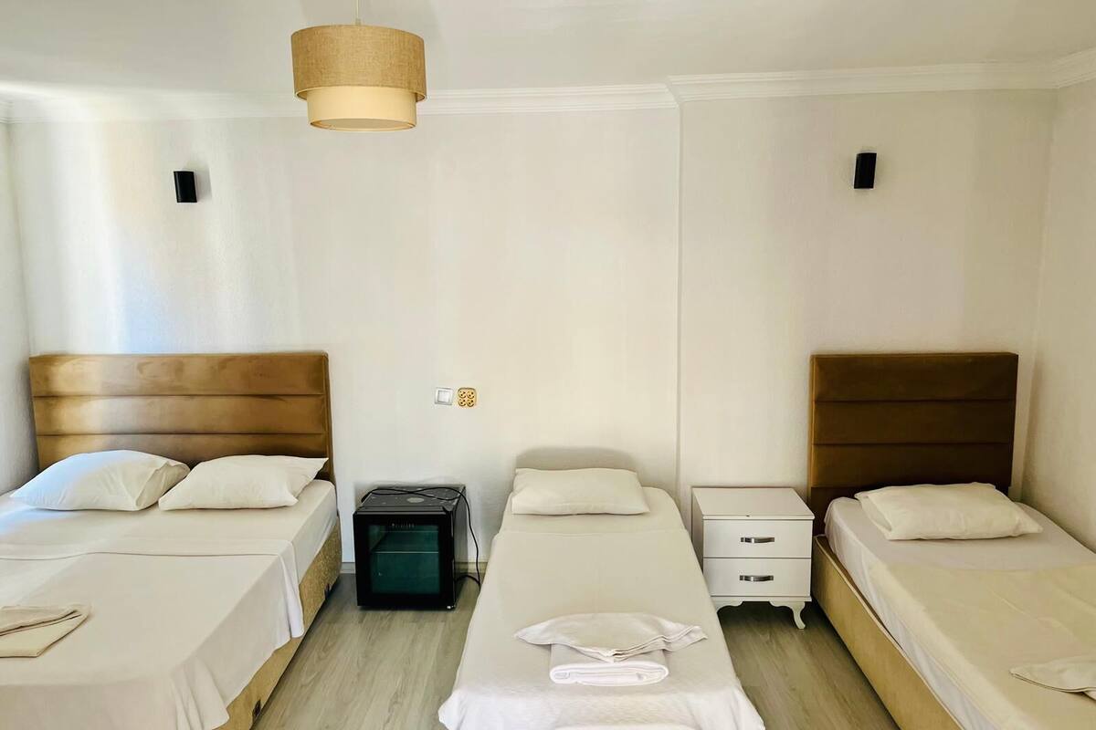 Triple Room | Desk, blackout drapes, iron/ironing board (on request), cribs (free)